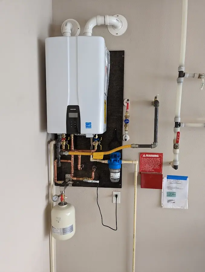 Professional plumber installing copper piping in a Grant home